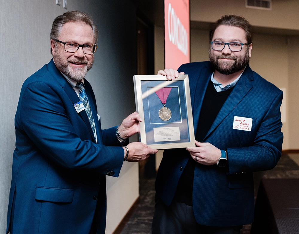 John addis recieves the AAF Silver Medal award and holds it up with his friend Dave from BRD.